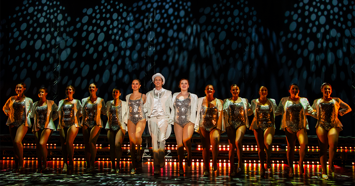 Jared Newall as Peter Allen with the Rockettes